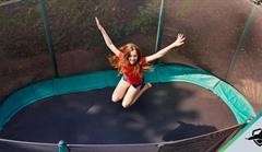 Girl jumping on trampoline