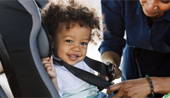 Putting young child in car seat